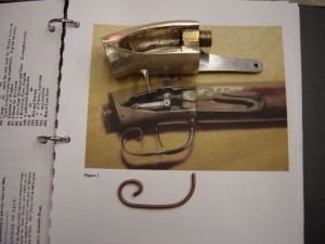 Bronze prototype casting with photo of original gun